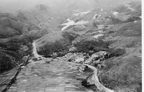 Shui Hau Village with its fields, and showing the South Lantau Road going through to the Shek Pik Reservoir site, both then under construction, 1959-60.