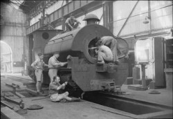 Royal Air Force personnel work to repair an engine for the Kowloon Railway, Hong Kong. This railway was immobilised during the Japanese occupation, services were restored under Royal Air Force supervision after the liberation. (photographs) Made by: Royal Air Force official photographer