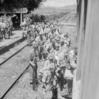 Japanese soldiers who were rounded up in the Fan Ling district of Hong Kong by men of the 3rd Commando Brigade are put aboard a train bound for Kowloon . photographs) Made by: No 9 Army Film & Photographic Unit