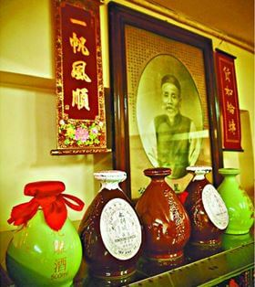 WING LEE Wai Winemaker Bottles Of Wine In Front Of The Portrait Of Founder Wong Sing Hui York Loss
