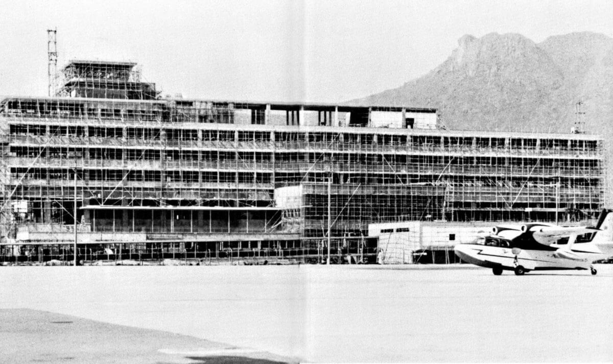MATCO Piaggio taxies past the new terminal at Kai Tak-1960